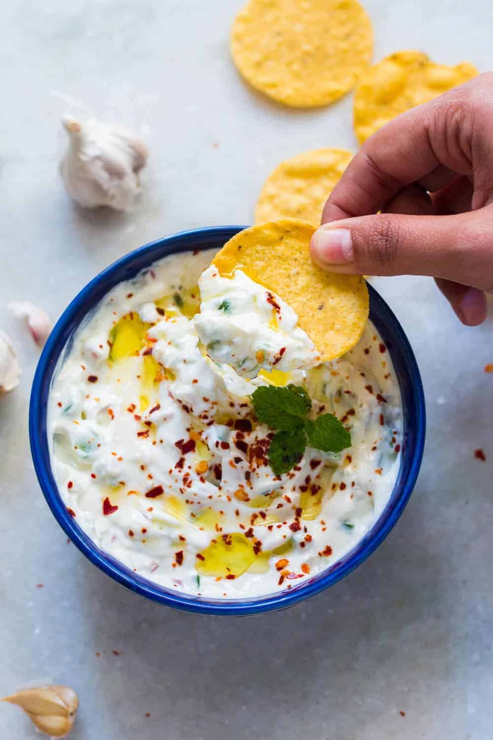 garlicky yogurt party dip served in a blue bowl