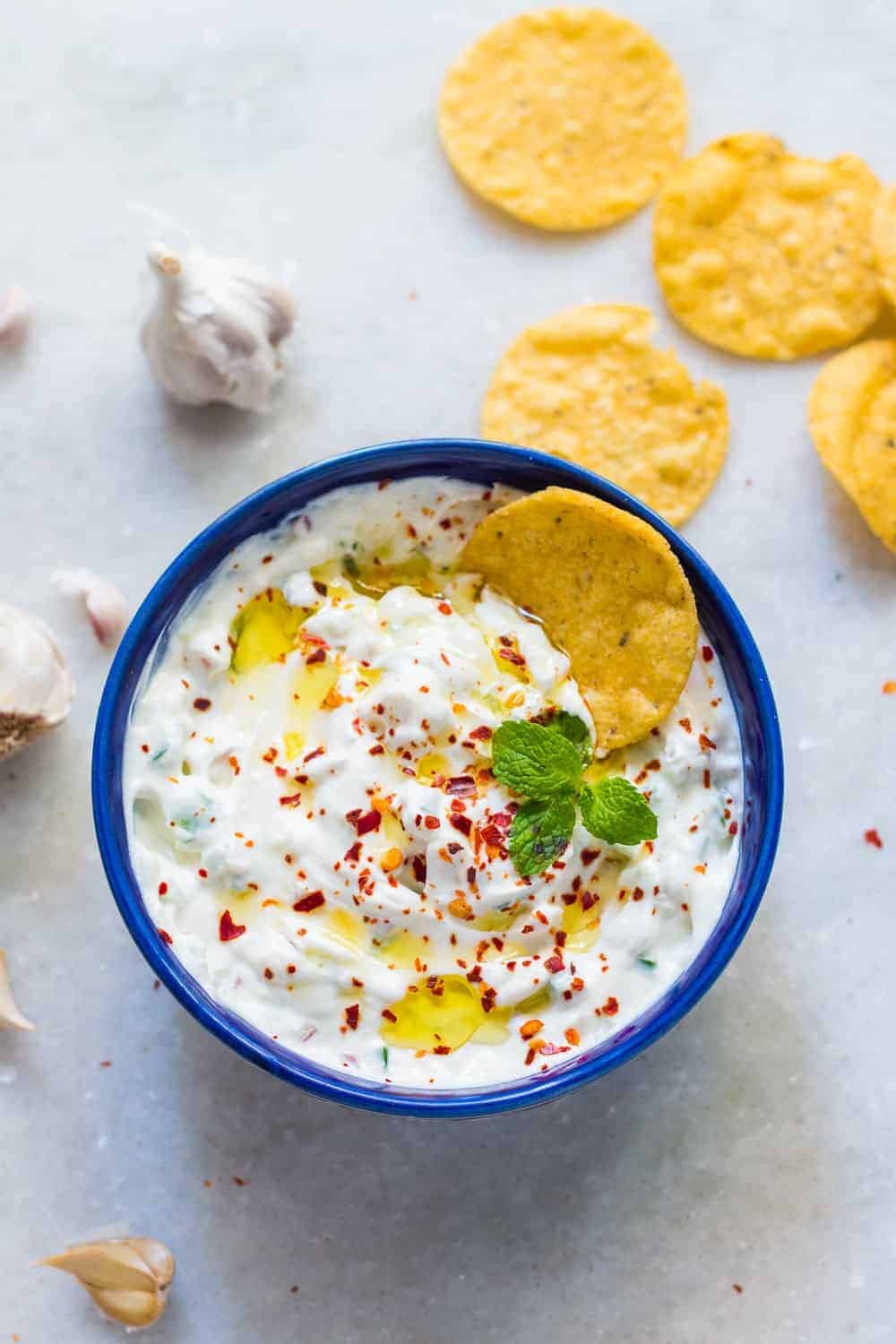 garlicky yogurt party dip served in a blue bowl