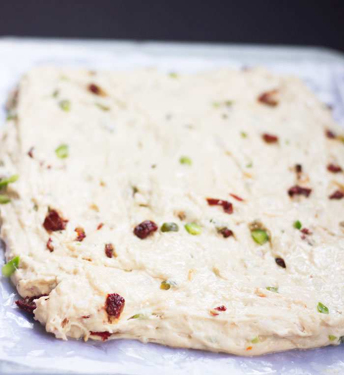 step by step image of pizza bread before it's baked
