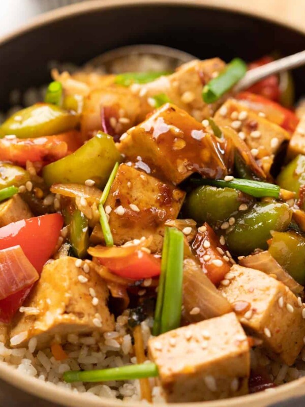 Sweet Chili Tofu Stir Fry served over rice in a bowl.