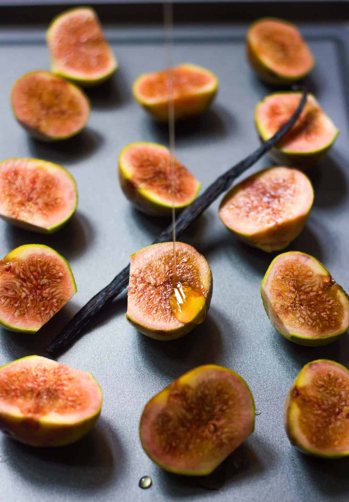 Honey being poured on the figs.