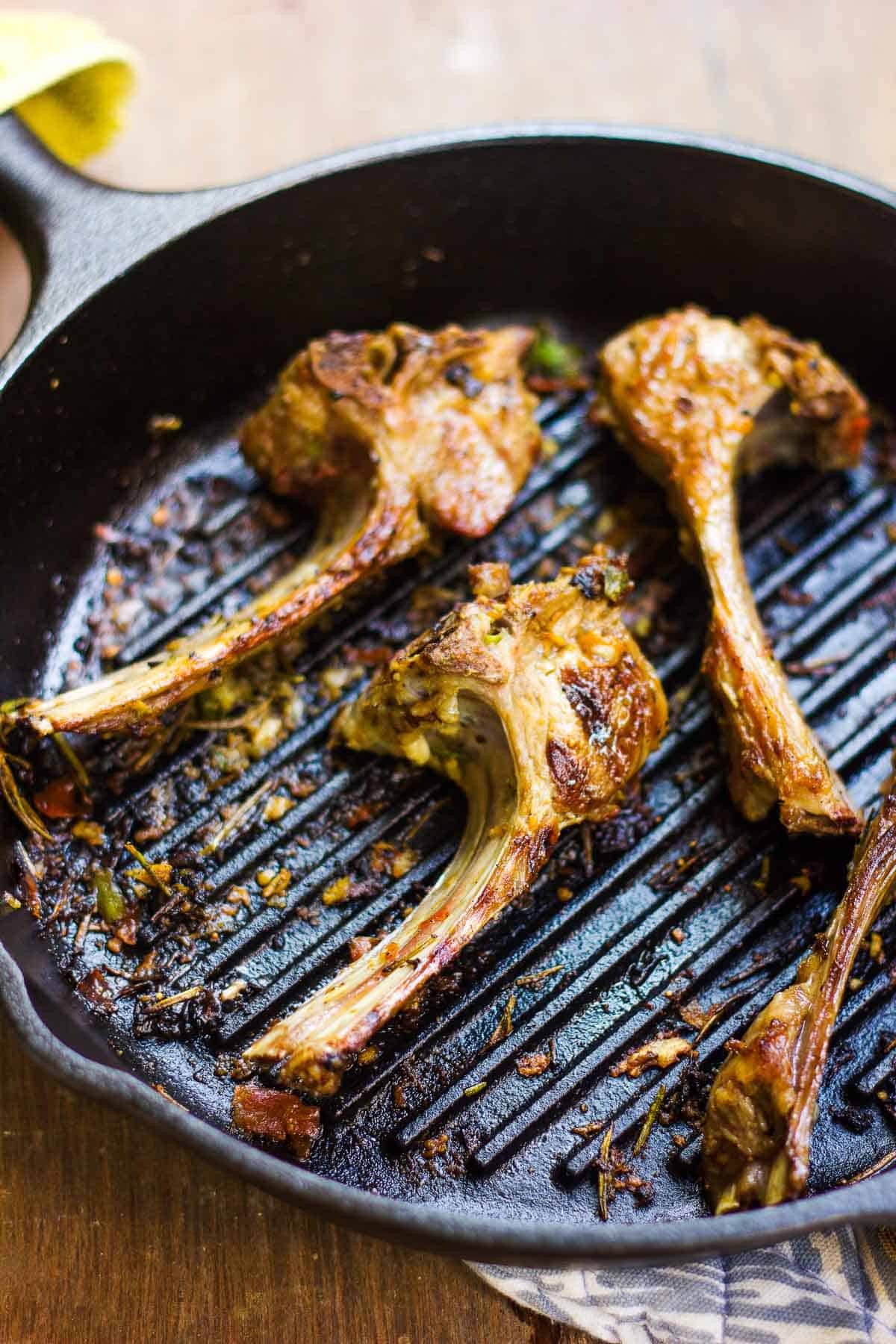 Spiced lamb chops in a pan.