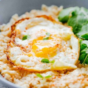Savory Garlic Oats with served with Masala Fried Egg and basil- a lip-smacking breakfast.