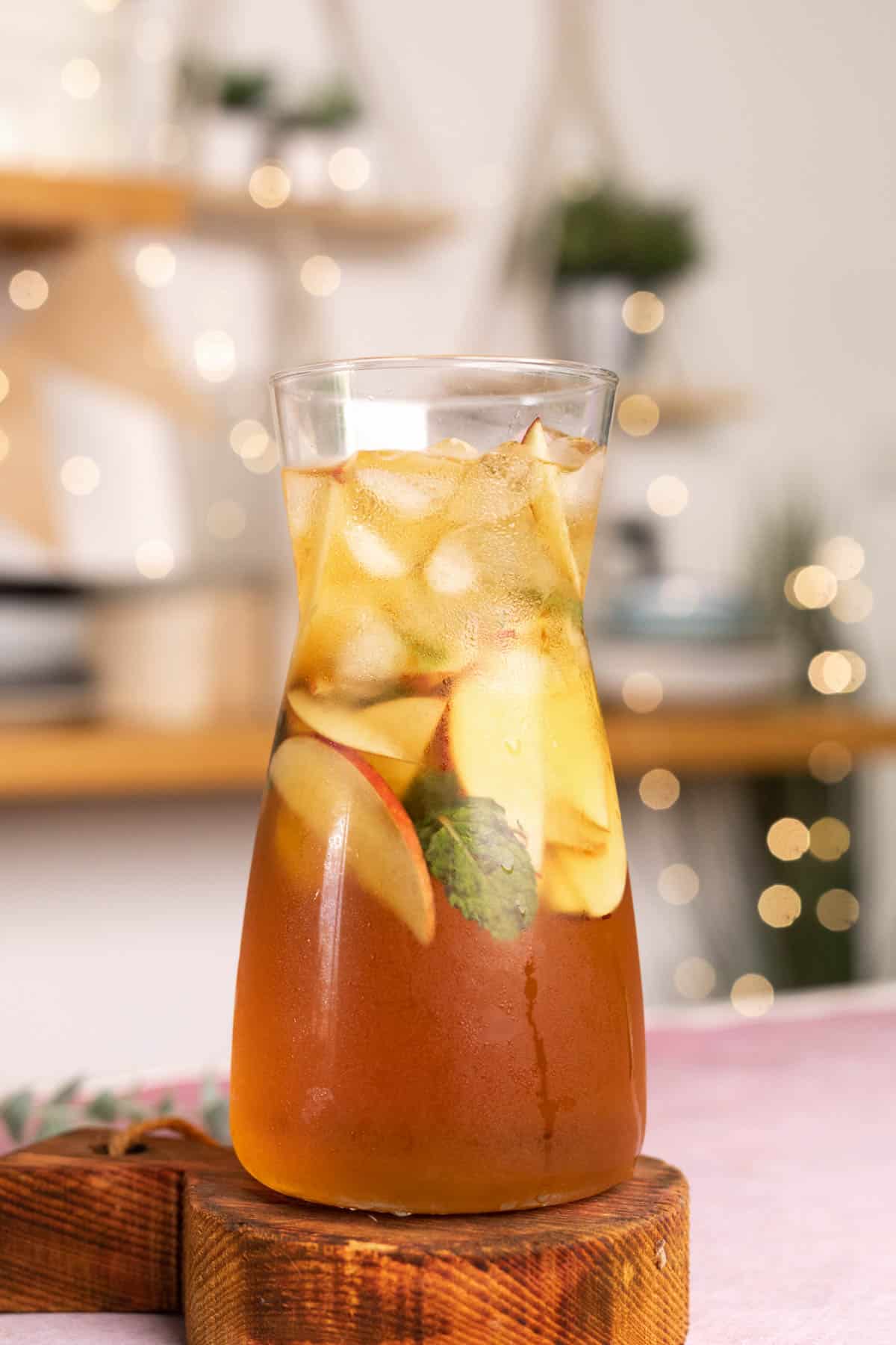 A pitcher of Virgin Apple Iced Tea with slices of apple inside