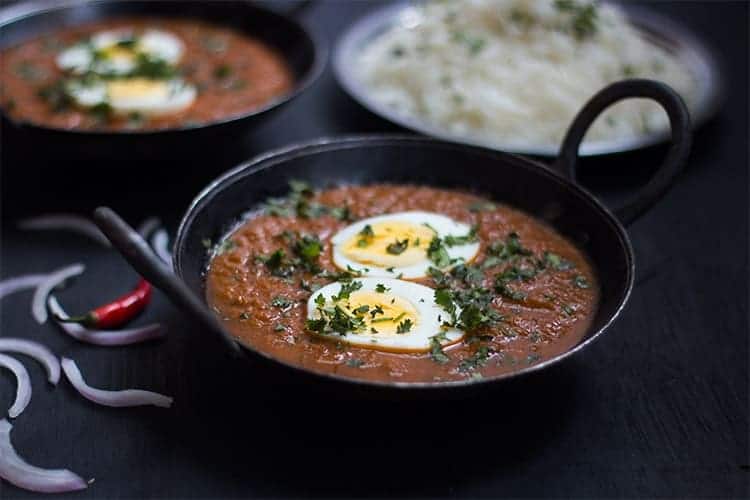 egg curry served in a small black kadhai