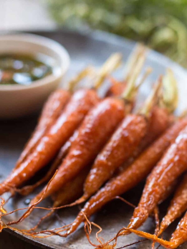 Honey Ginger Roasted Carrots plated with Carrot Greens Chimichurri.
