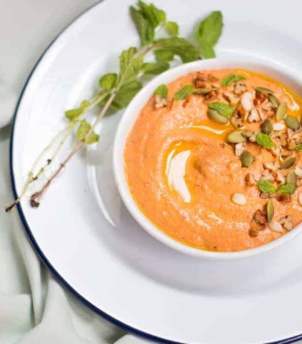 The dip garnished with pumpkin seeds