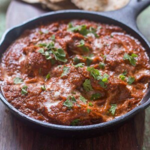 The healthier version of Chicken Tikka Masala garnished with coriander in a pan.
