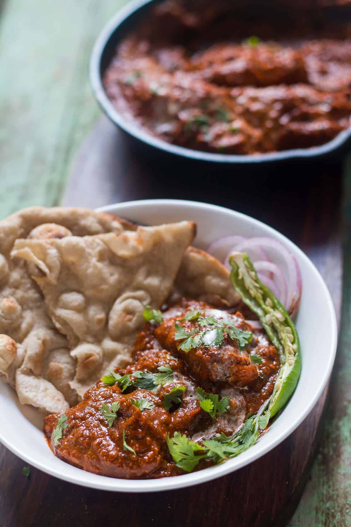 The Zero Oil Chicken Tikka Masala plated with tandoori rotis, onions and chili.