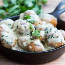 The Creamiest No Mayo Parsley Baby Potatoes in a black skillet.