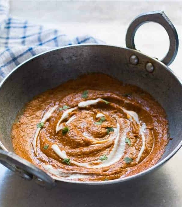 The curry base in a large pan/ kadhai.