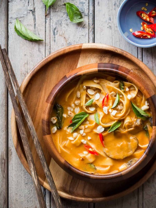 Creamy, comforting spicy thai curry pumpkin noodle soup served in a bowl.