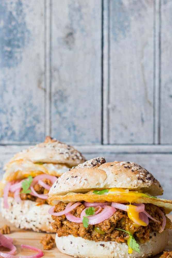 keema pav burger served on a brown board