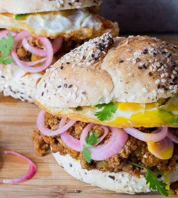 The Keema Pav Burger/ Indian Lamb Sloppy Joes served on a wooden board.