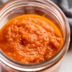 Cooked pasta sauce in a jar ready to be stored