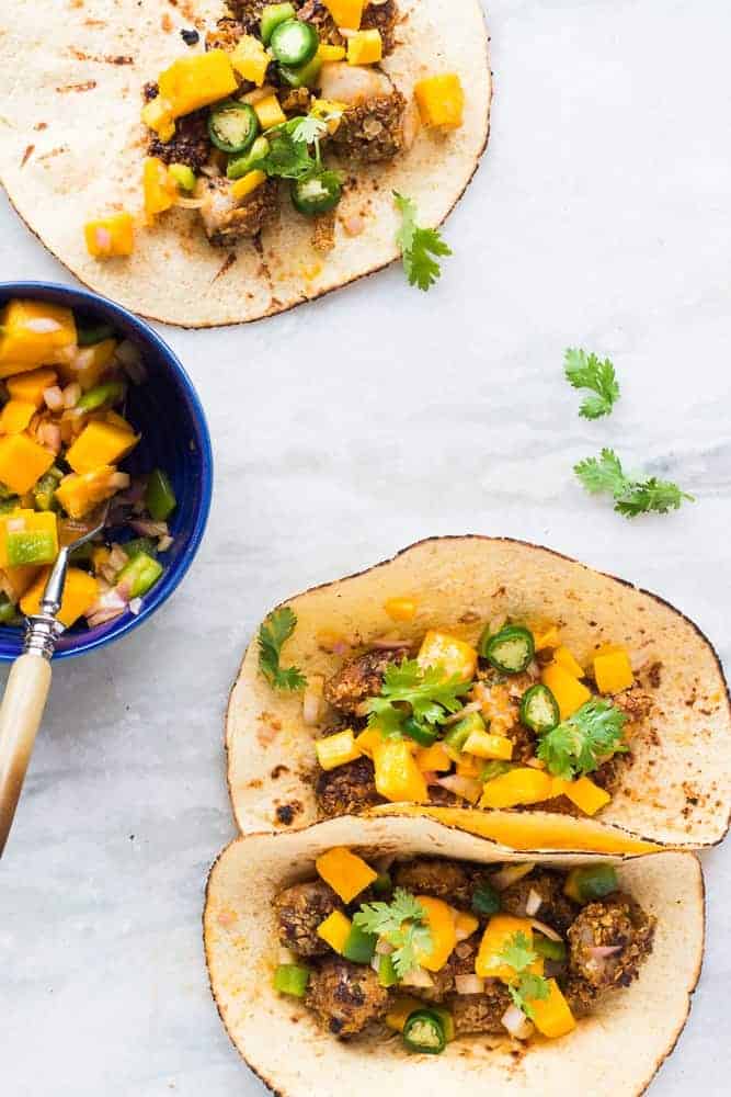 Healthy Oats Crusted Fish Tacos + Mango Salsa This recipe for super easy, healthy oats crusted fish tacos takes ONLY 15 mins from start to finish. Use cod, tilapia, red snapper or any other white fish. Instead of the usual cabbage slaw, I topped these with cilantro mango salsa for extra zing! Perfect for your next dinner/barbecue this summer!