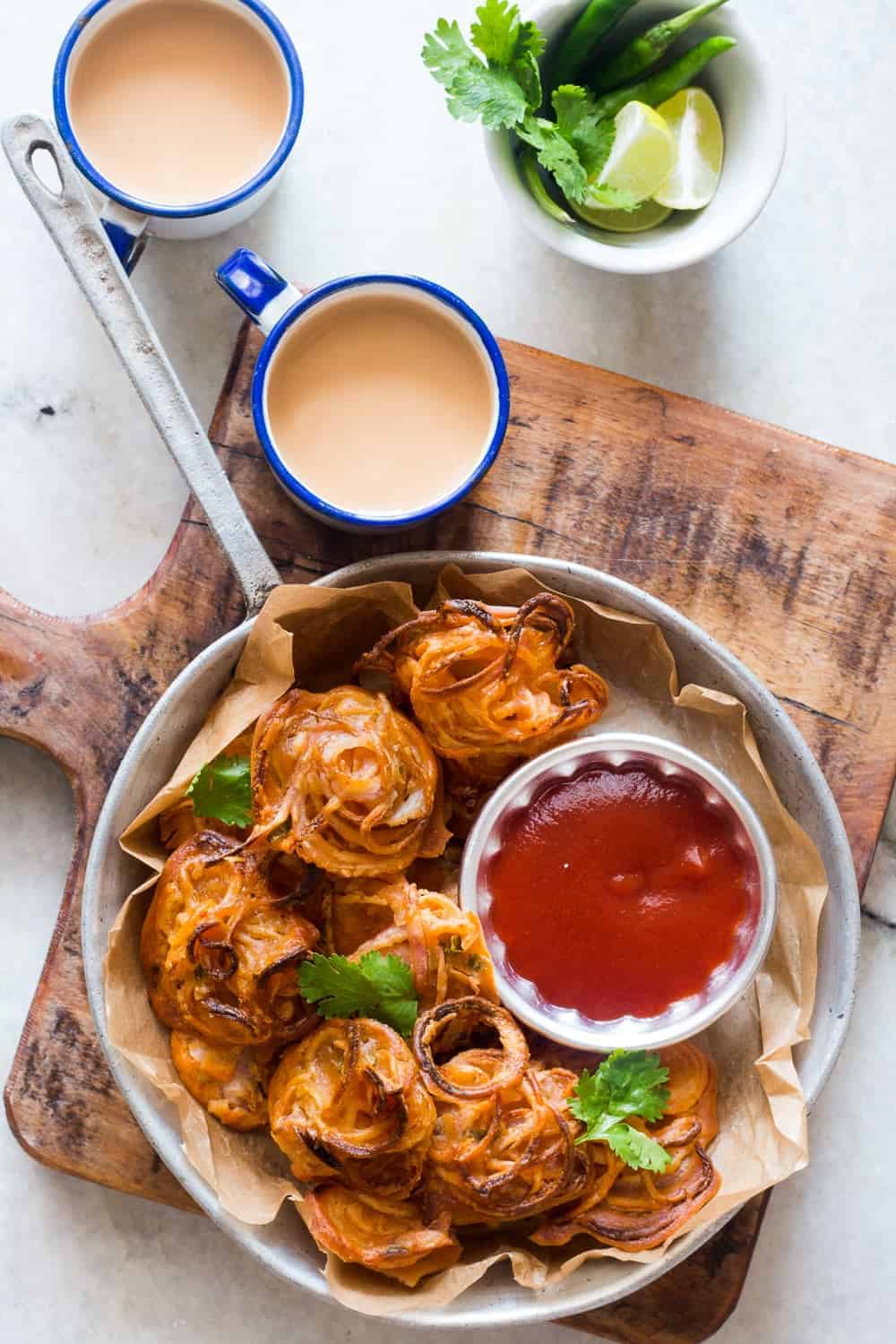 Crispy Baked Onion Pakodas (Fritters) Indians love their pakodas and bhajiyas (fritters) and now there's a guilt-free way to enjoy them with a cup of masala chai. Nobody's ever going to believe these onion pakodas are baked, not fried! Can be made with potato, corn, capsicum and paneer too!