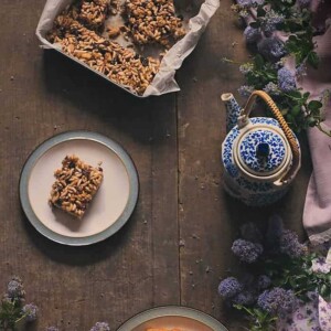 Raisin Chocolate and Puffed Rice Bar cut out and served on a white plate.