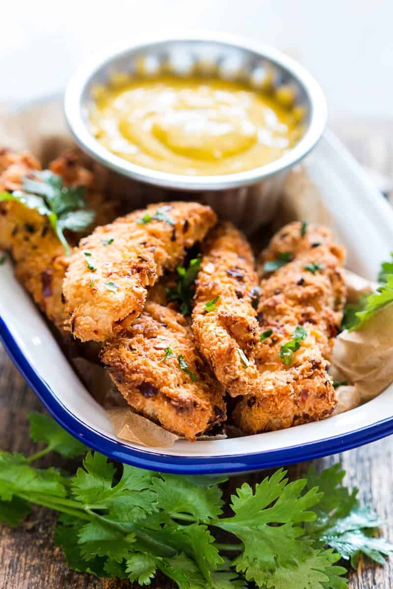 Baked Coconut Chicken Tenders with Mango Mustard Sauce Easy recipe for super crunchy baked coconut crusted chicken tenders which are going to be a favourite at every party with kids and adults alike! Gluten free too.