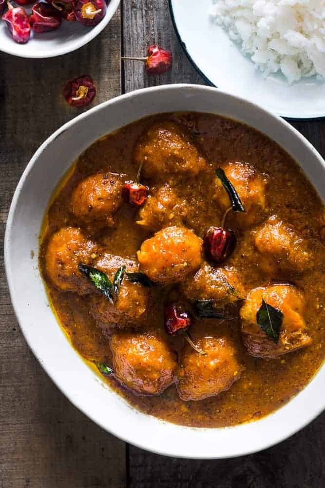 A collection of 13 insanely delicious savoury mango recipes that are sure to blow your mind if you've always had mangoes in sweet dishes. These recipes combine the juicy sweetness of mangoes with savoury ingredients to create a dish that's truly stellar and unforgettable! #spring #mango #recipes #easter #summer #fruit Ripe mango curry in a large white bowl served with rice