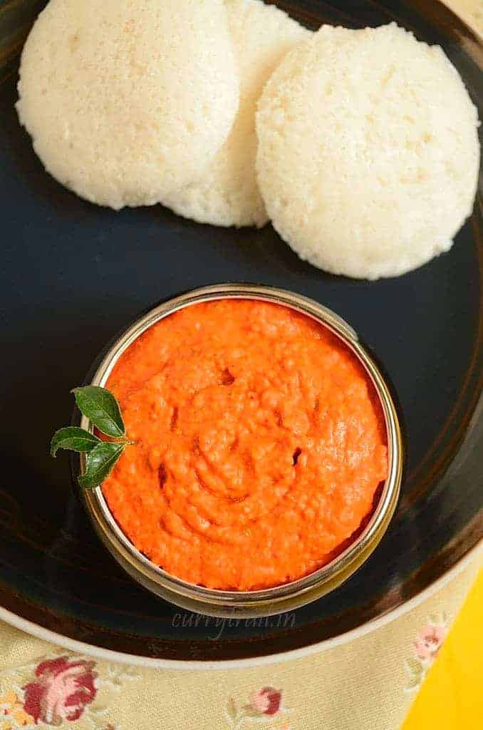 A collection of 13 insanely delicious savoury mango recipes that are sure to blow your mind if you've always had mangoes in sweet dishes. These recipes combine the juicy sweetness of mangoes with savoury ingredients to create a dish that's truly stellar and unforgettable! #spring #mango #recipes #easter #summer #fruit Reddish raw mango chutney served in a bowl with idlis
