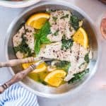 Bhetki Fish in Citrus Basil Butter Sauce served with a side of wine.