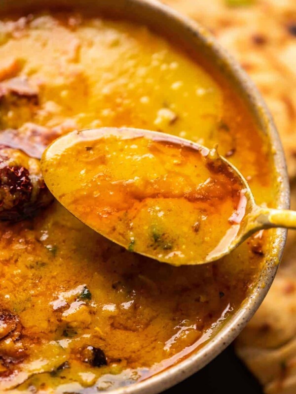 A spoonful of dhaba dal tadka being taken out of the bowl