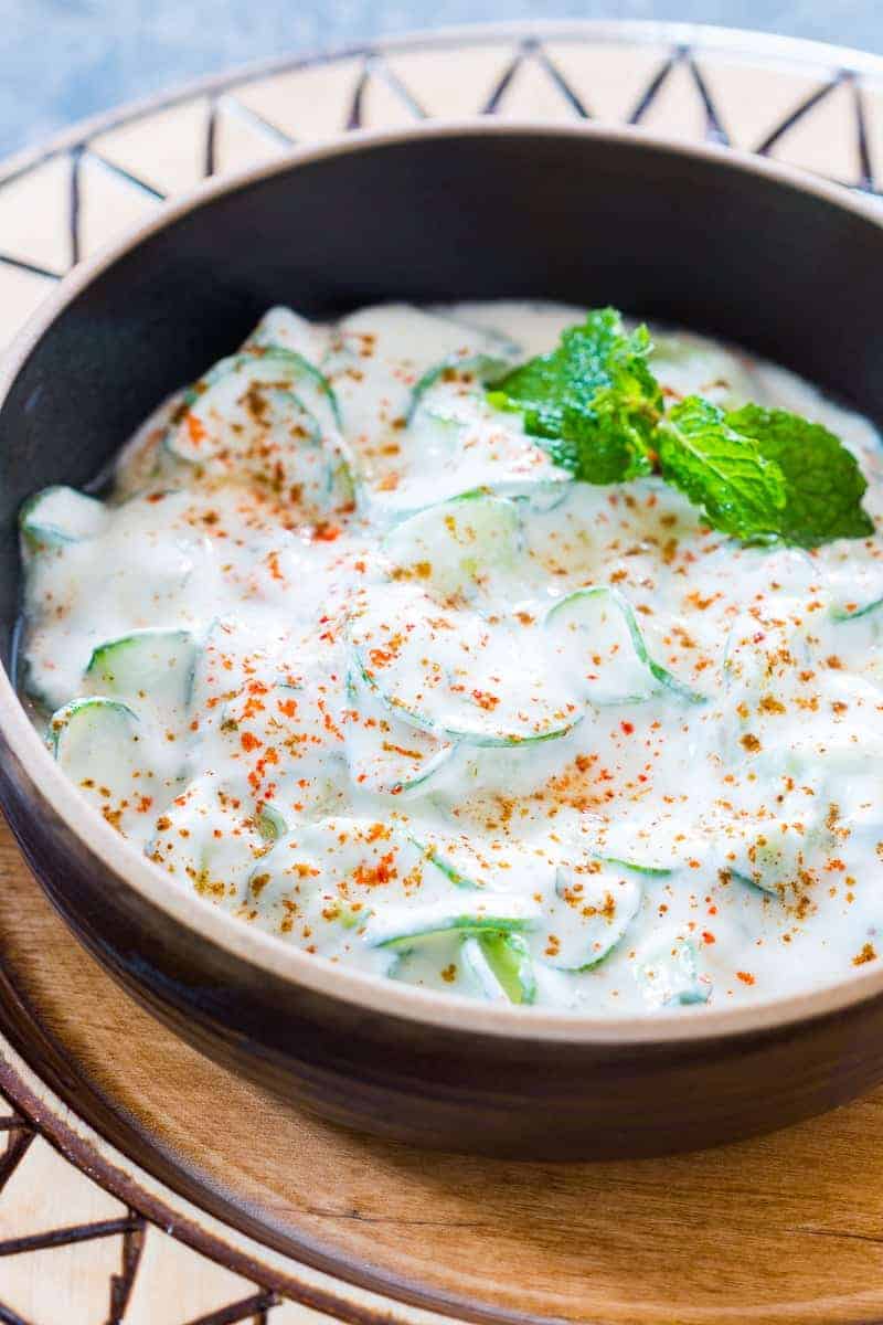 indian spiralized cucumber mint raita served in a black bowl
