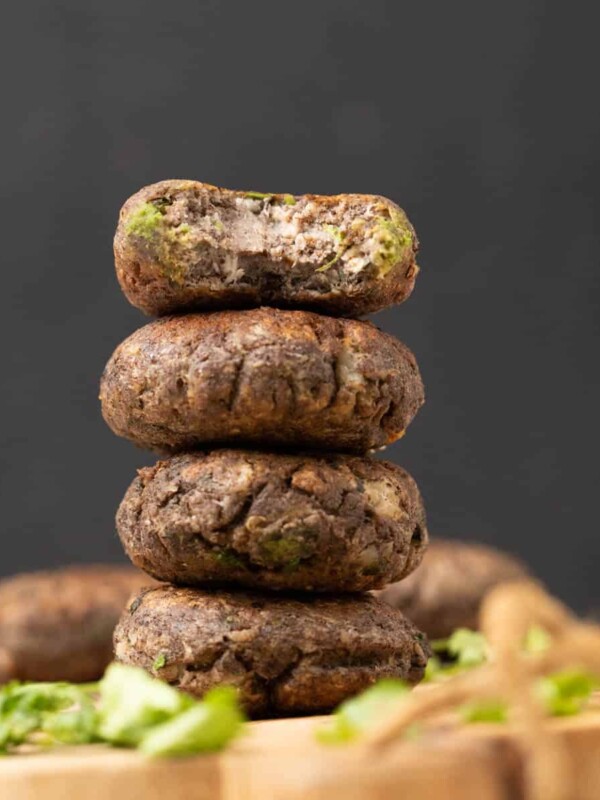 raw banana tikki or Kachhe kele ke kebab garnished and served on a brown board