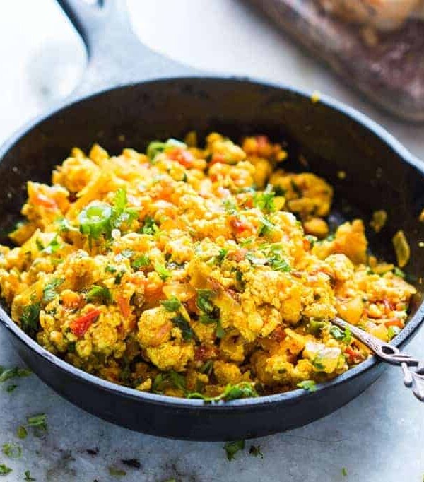 Paneer bhurji in a black skillet.