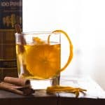 Orange Cinnamon Whisky Smash served with orange peels in a glass.