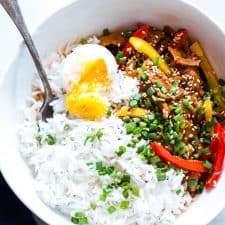 Slow Cooker Korean Pork Bulgogi with Gochujang served with egg and rice in a white bowl.