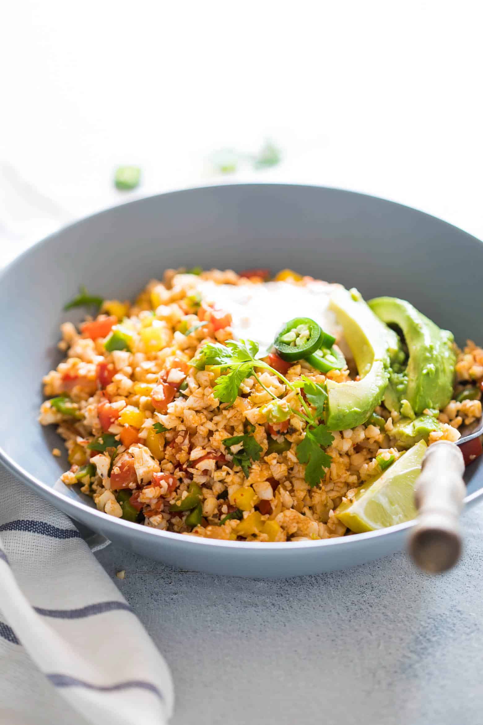 Low Carb Mexican Cauliflower Rice is a healthy, paleo friendly, keto friendly, vegan side dish recipe that is bursting with mexican flavours and ready in 30 minutes!