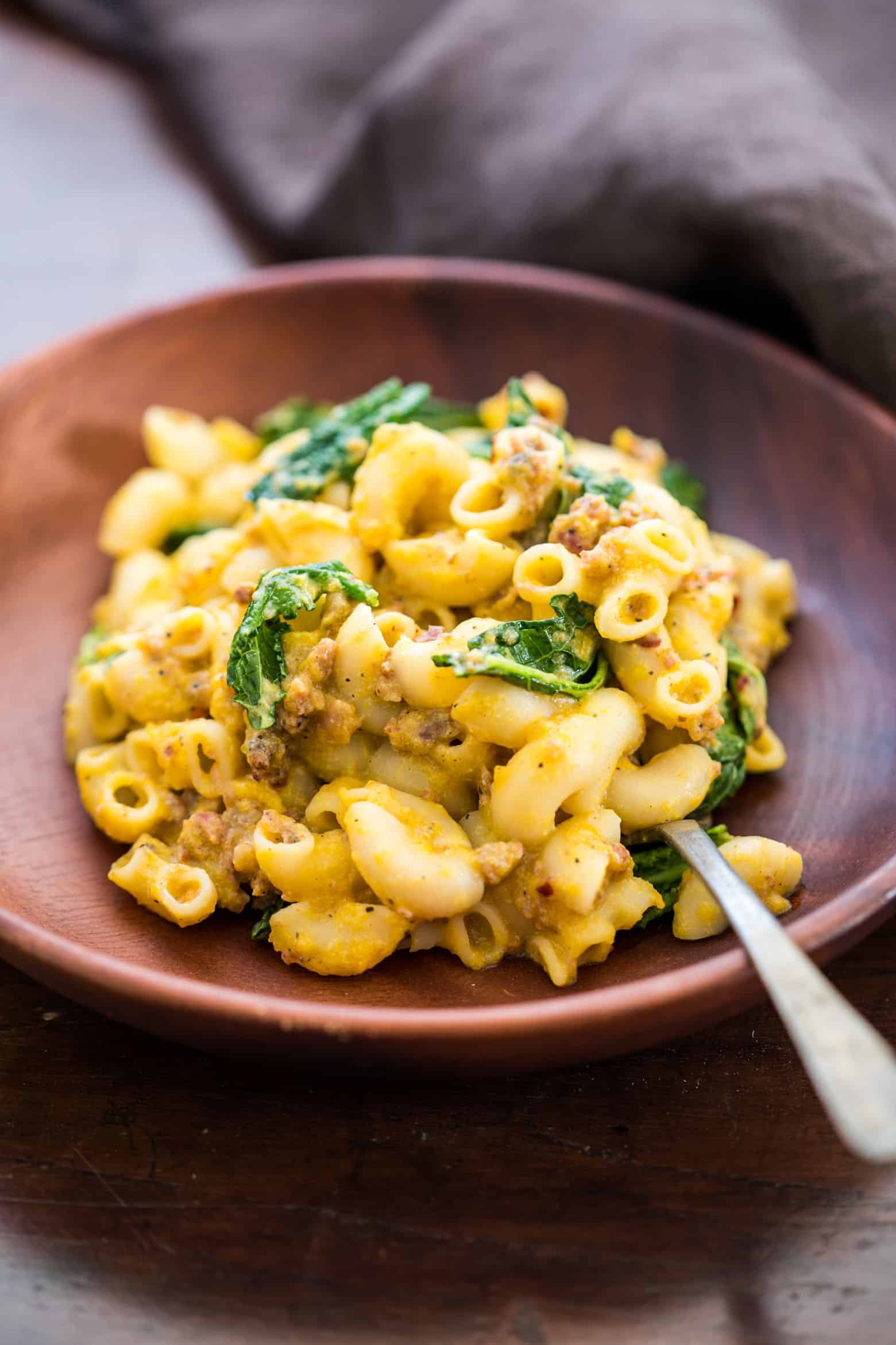 Creamy pumpkin sausage mac and cheese with kale is pure comfort food! It's a fast, easy dinner recipe when you crave homemade pasta
