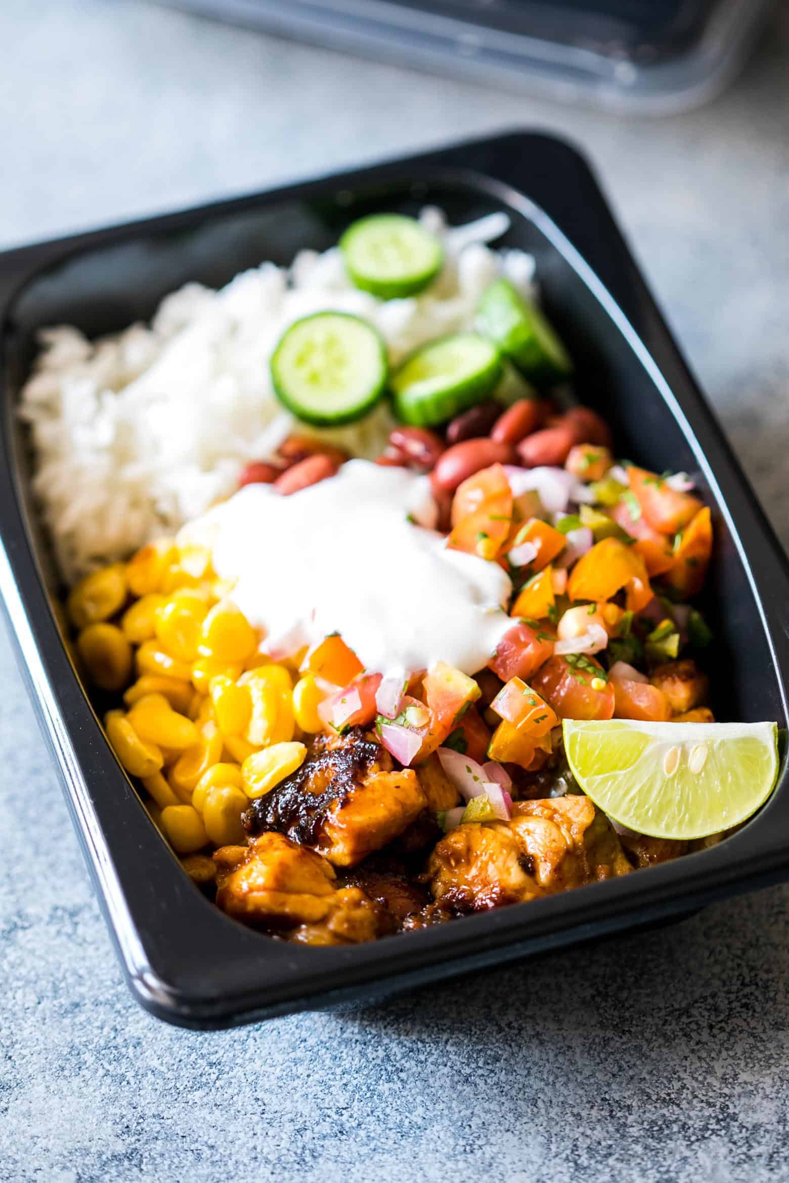 Easy chicken burrito meal prep bowls are perfect for planning weekday work lunches ahead! They are super tasty, gluten free and a healthy way to make sure you have home cooked lunch boxes ready to go.