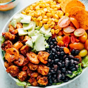 Ingredients of the salad assembled together in a white bowl.