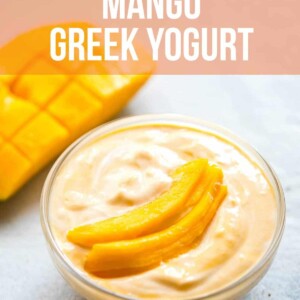 Mango greek yogurt served in a bowl with sliced mango on top