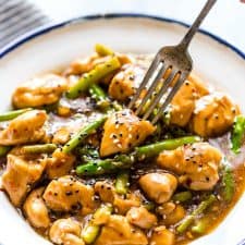 Lemon Ginger Chicken Asparagus Stir Fry served on a white plate.