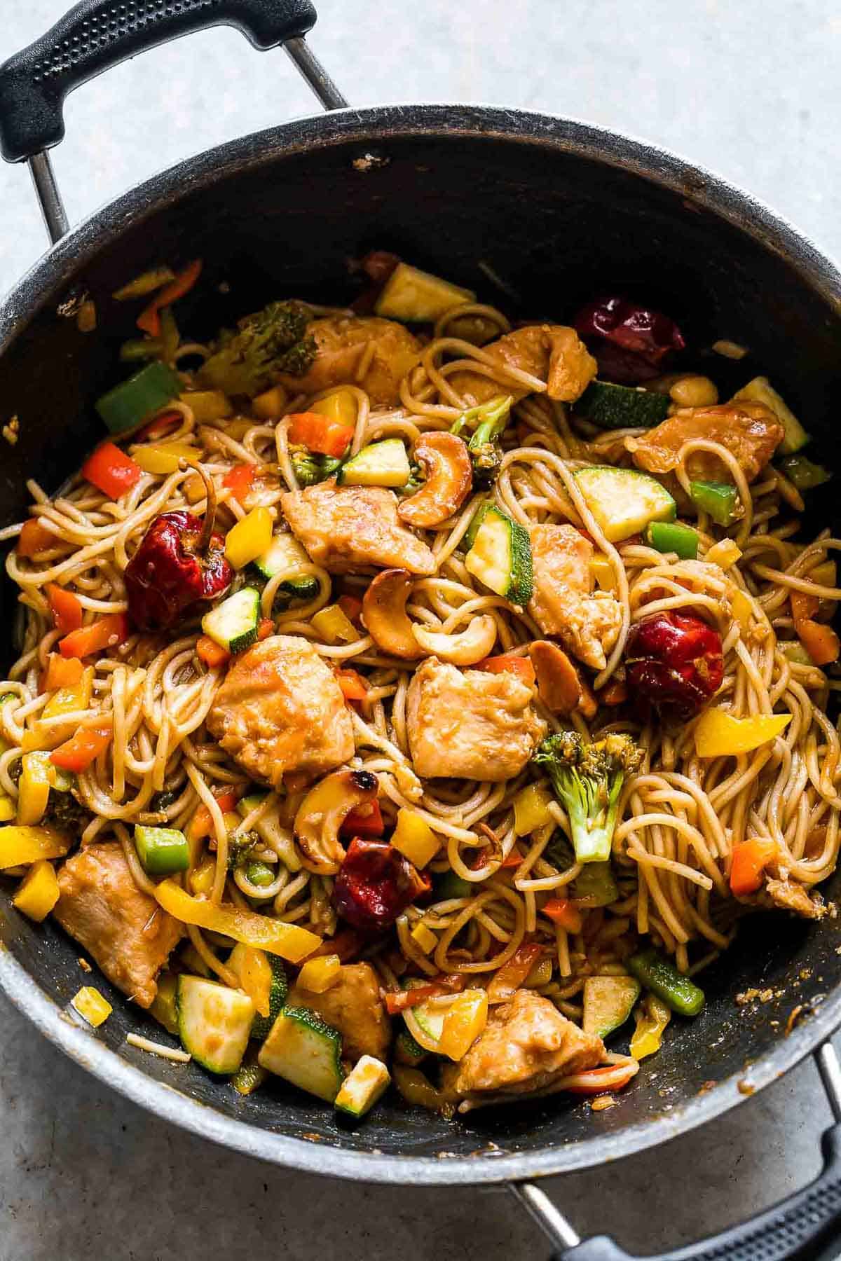 Chinese Cashew Chicken Noodles Stir-Fry in a pan.
