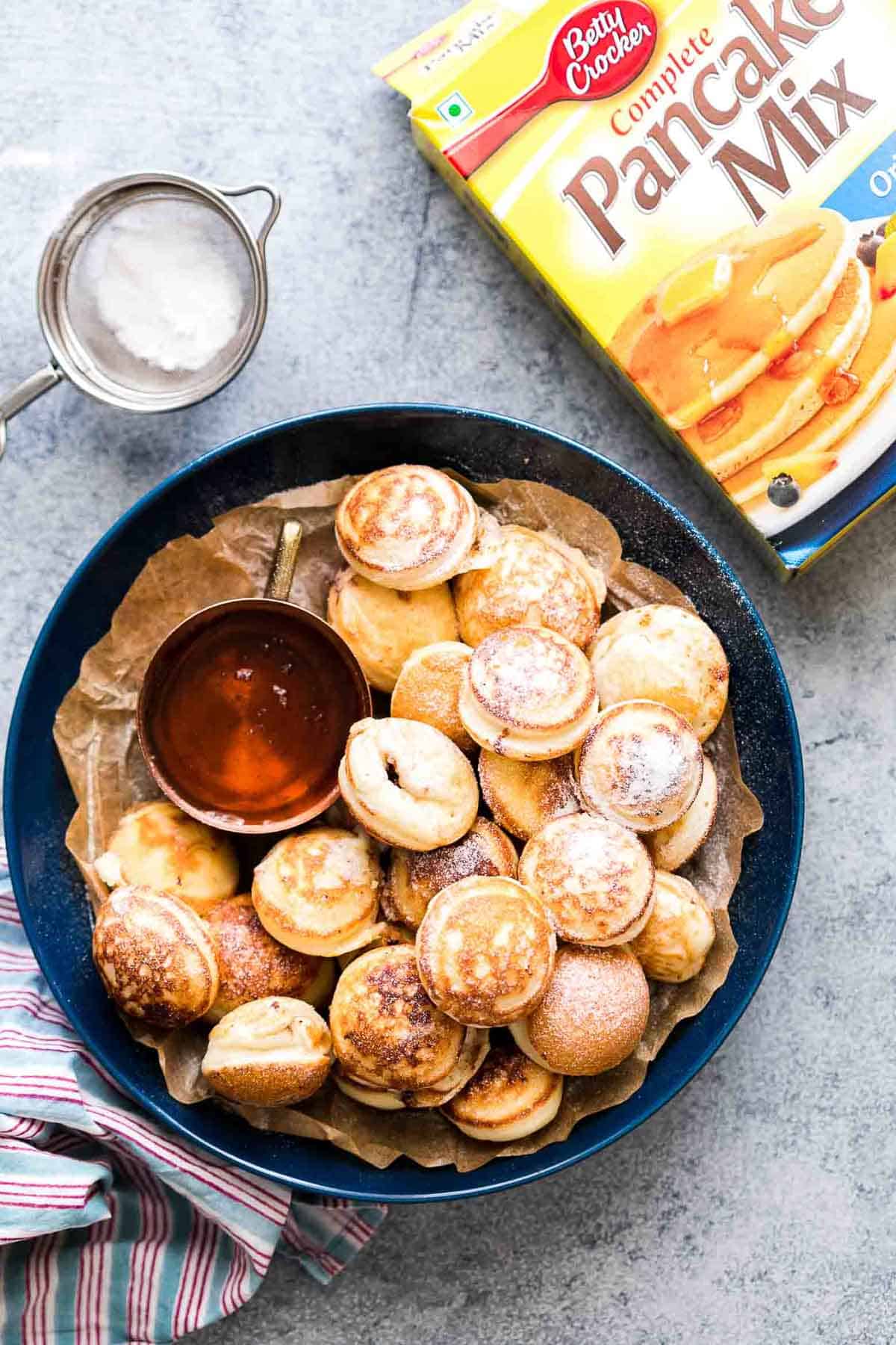 Chocolate Stuffed Mini Pancake Bites served with maple syrup on the side.