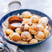Chocolate Stuffed Mini Pancake Bites served with maple syrup on the side.