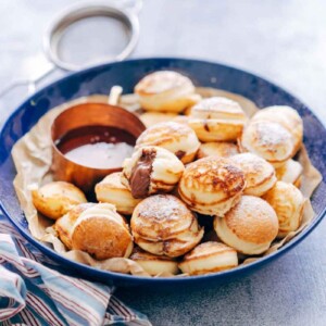 Chocolate Stuffed Mini Pancake Bites served with maple syrup on the side.