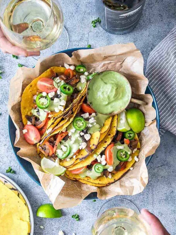 Vegetarian Portobello Mushroom Fajita Tacos served with avocado cilantro sauce on the side and being enjoyed with Big Banyan's Chardonnay white wine.