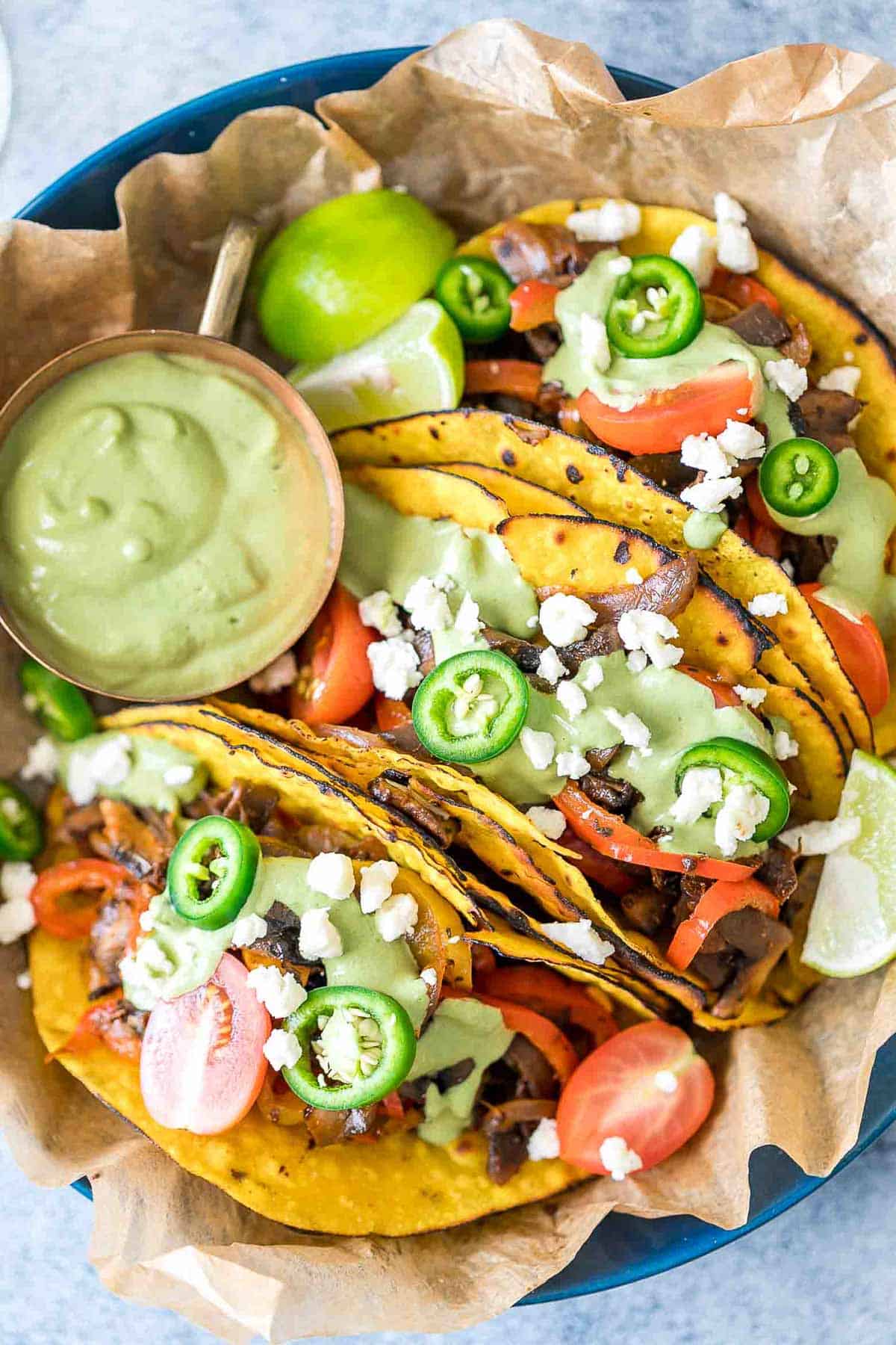 Vegetarian Portobello Mushroom Fajita Tacos served with avocado cilantro sauce on the side.