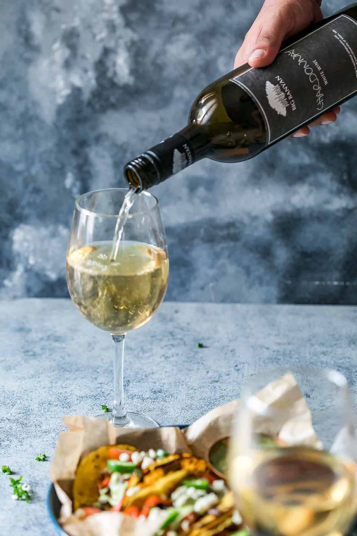 Vegetarian Portobello Mushroom Fajita Tacos paired with a glass of Big Banyan's Chardonnay white wine.