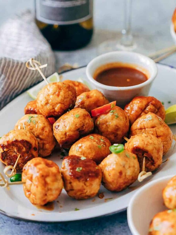 Baked firecracker chicken meatballs are juicy, spicy and saucy! This easy appetizer is perfect for holiday parties. Each meatball is super tender and full of flavour.