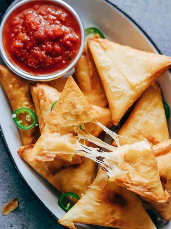 Super cheesy jalapeno three cheese samosa are sure to become a favourite because who can resist gooey stringy cheese stuffed in crispy samosa wrappers! These vegetarian samosas have a filling of mozzarella, cream cheese, smoked cheddar and jalapenos and folding them is really easy too.ย