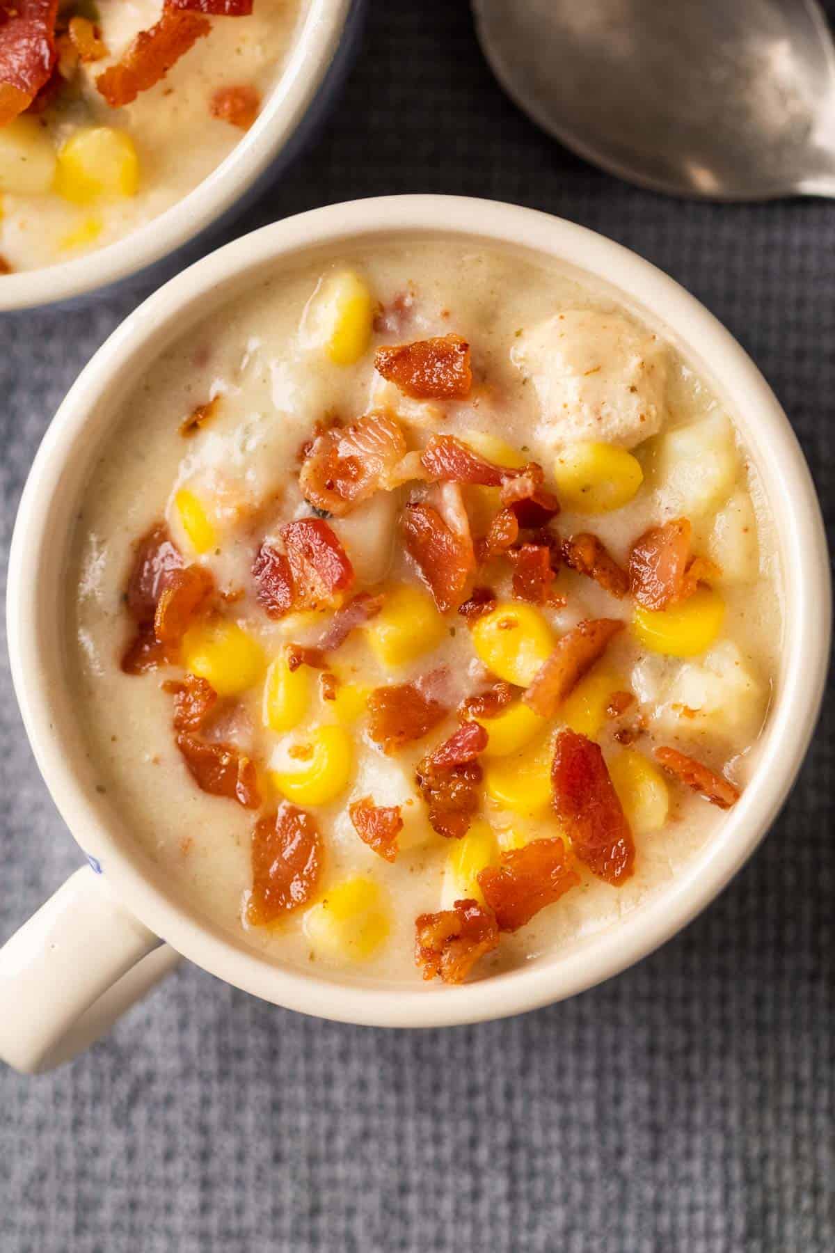 Picture of instant pot chicken potato corn chowder served in a bowl with bacon sprinkled on top