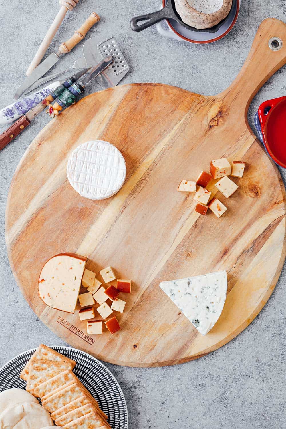 Step #2 to making the ultimate wine and cheese board on a budget is to pick the right cheeses. Pictures here is smoked jalapeno cheddar, brie and danish blue cheese