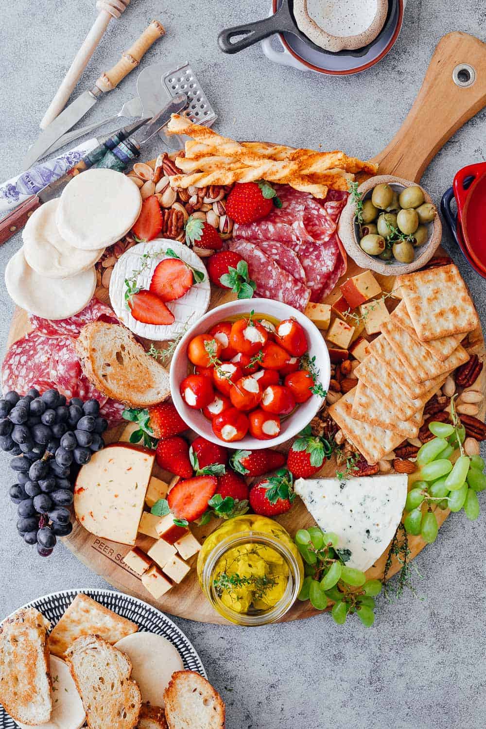 Step #6 in creating the ultimate wine and cheese board on a budget is to add crackers and toasted breads